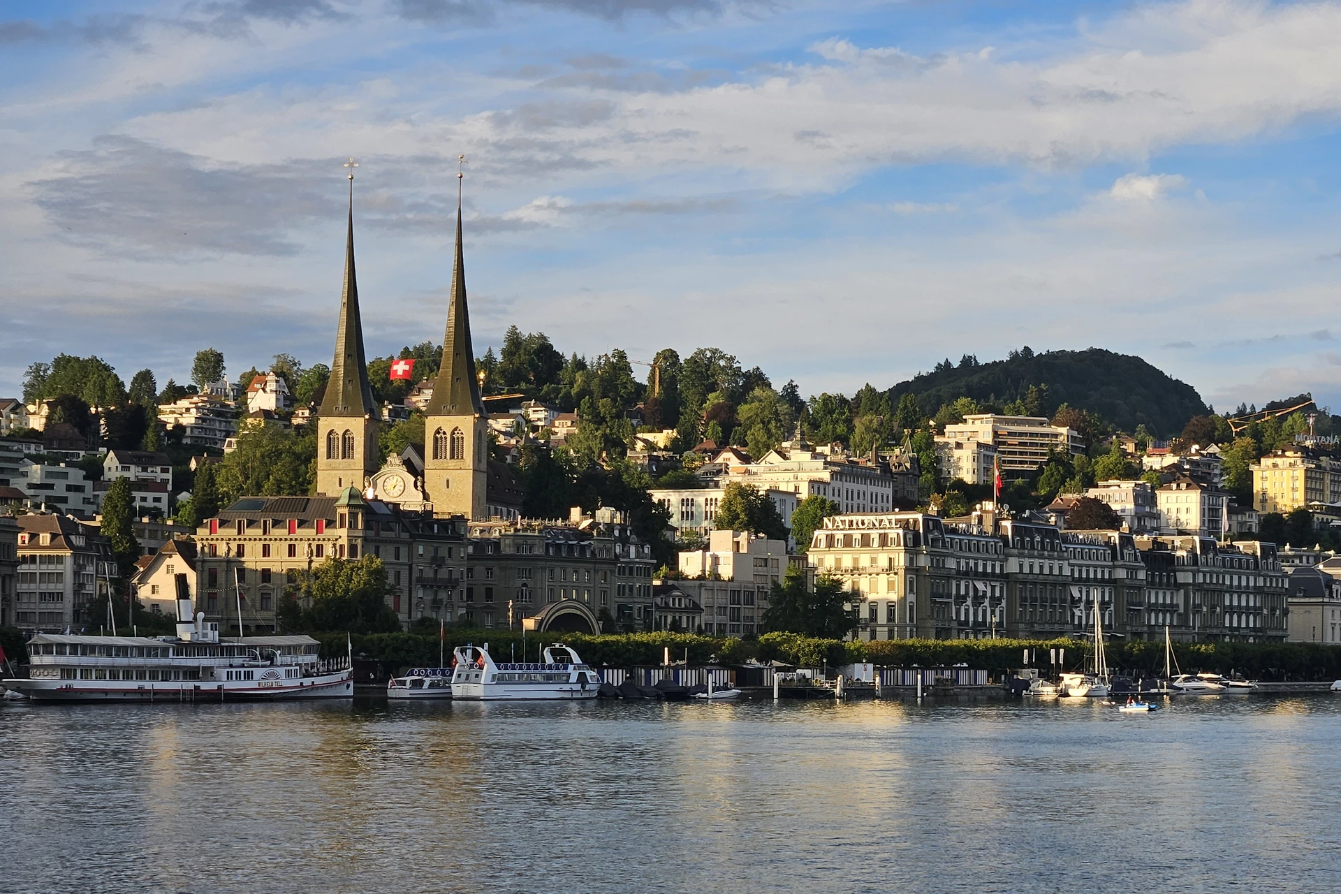 Traditional and historic buildings lining the Lucerne waterfront including the twin-towered Church of St. Leodegar