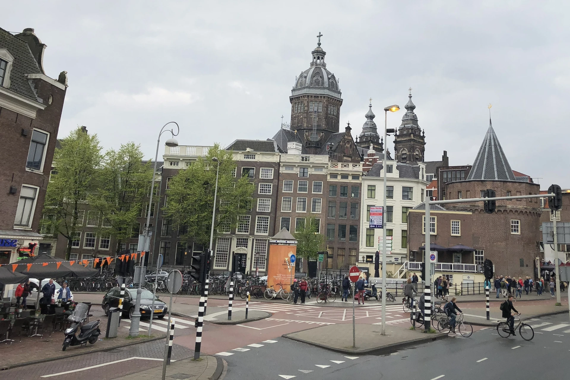 Street view in Amsterdam with the prominent dome of the Basilica of Saint Nicholas