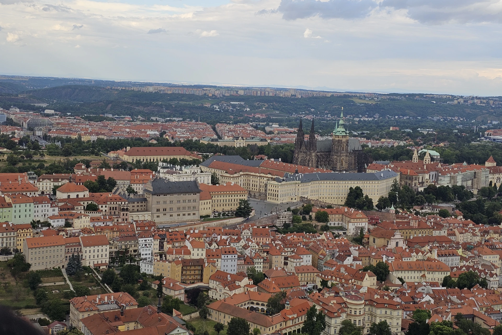 Prague skyline showing distinct terracotta rooftops around Prague Castle as viewed from the Petřín Tower