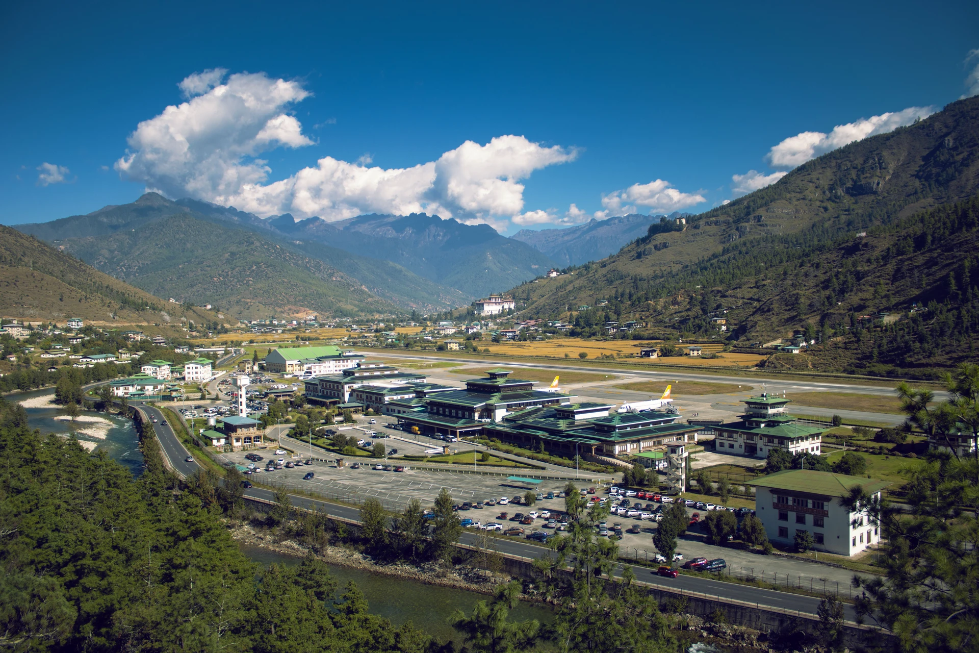 Airport terrain with distant mountains and green vegetation