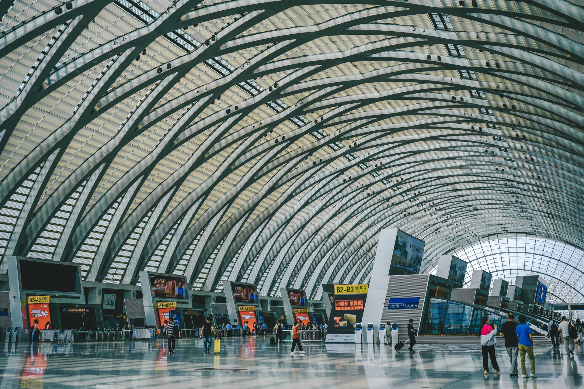 Airport terminal interior with angled ticket counters and signage